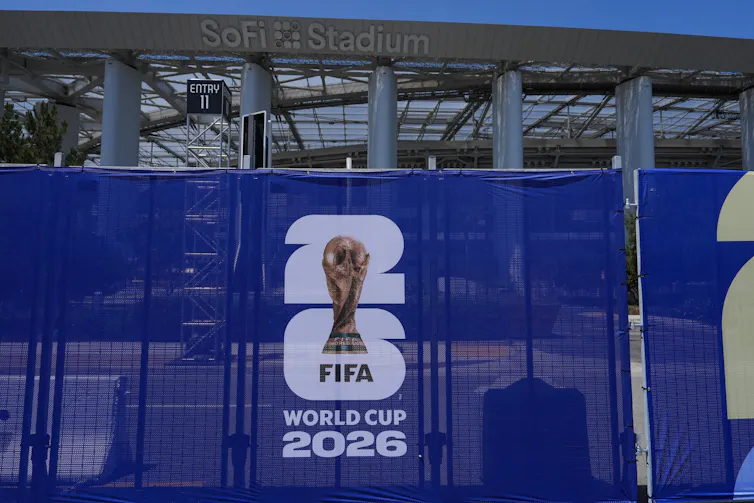 A closeup of the 2026 FIFA World Cup logo on a blue fence