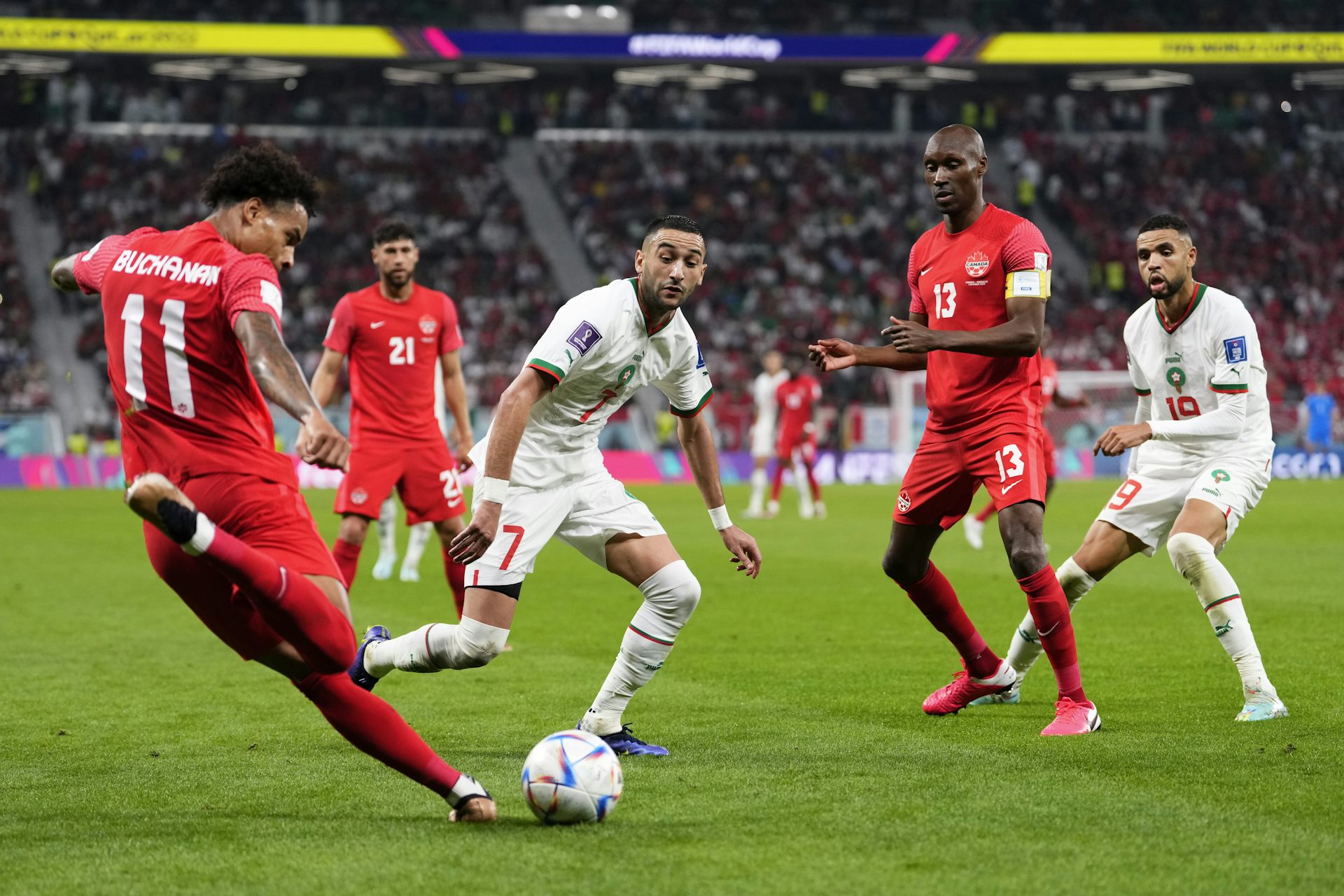 Two players battle for the ball on a soccer field
