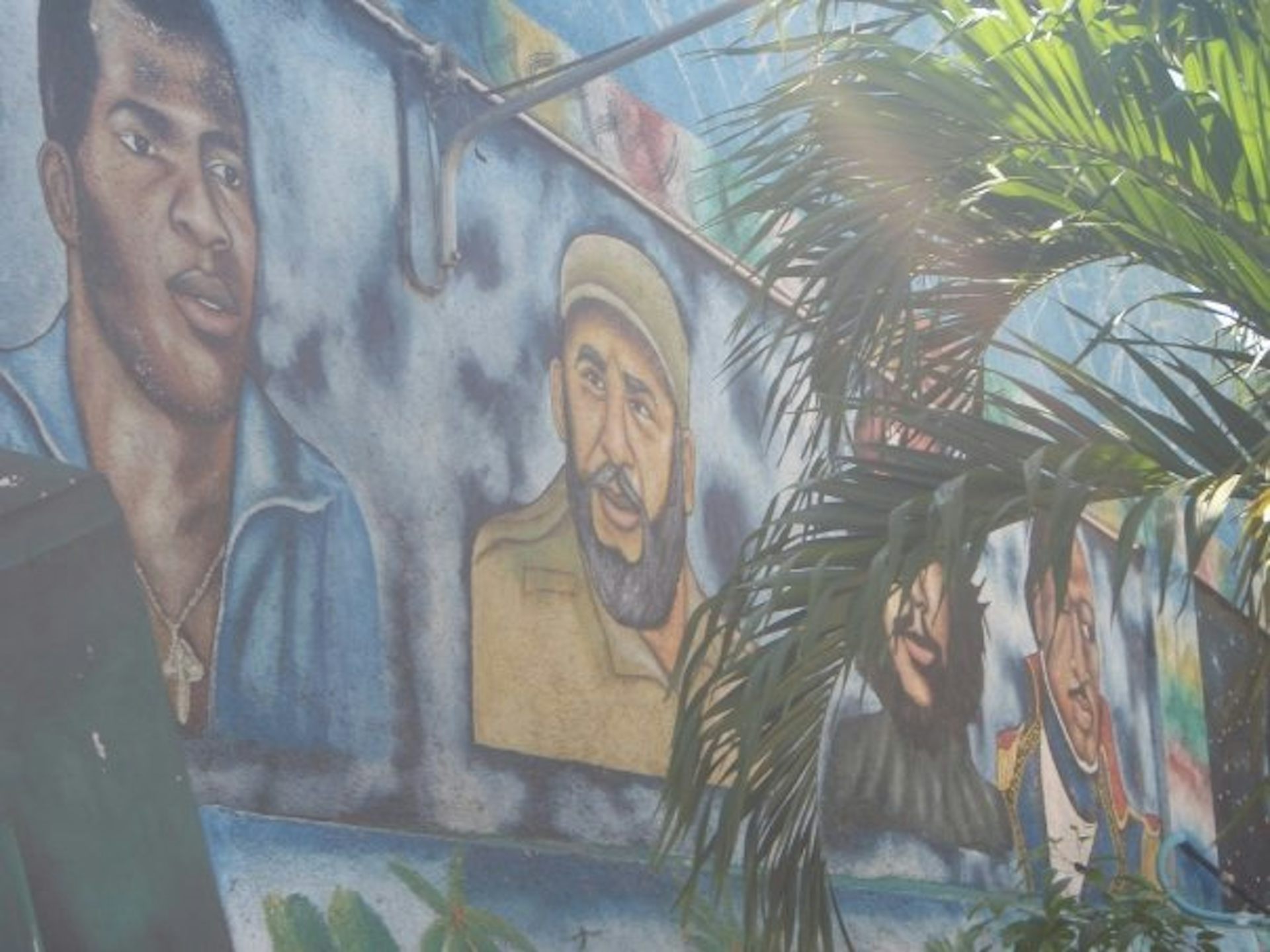 A large mural shows people's faces.