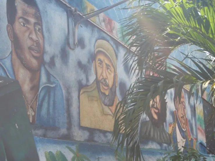 A large mural shows people's faces.