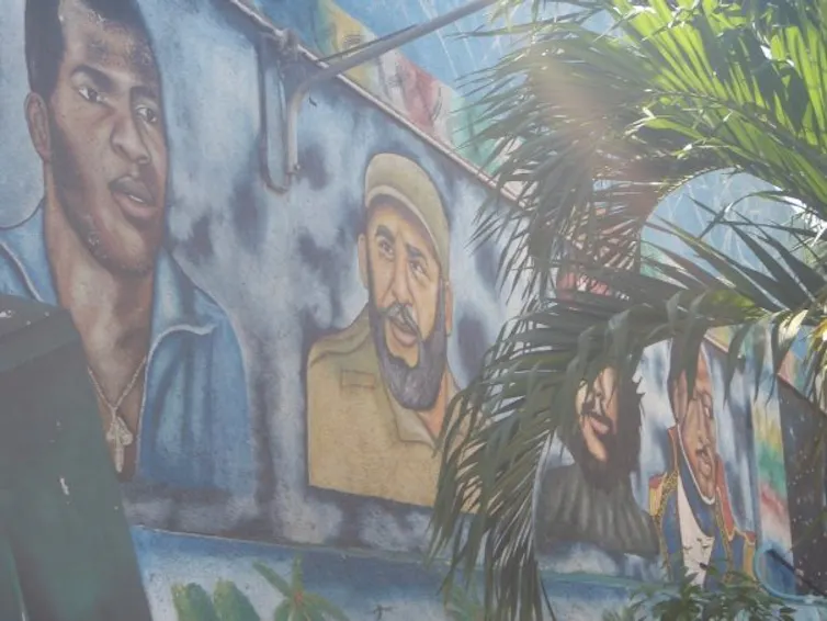 A large mural shows people's faces.