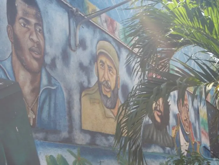 A large mural shows people's faces.