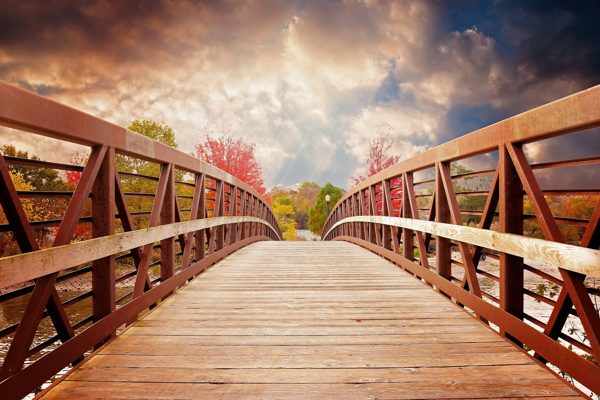 A wooden footbridge with a landscape beyond