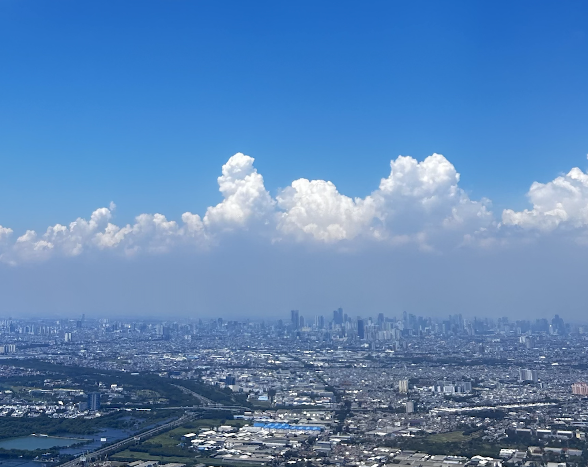Air pollution haze covering Jakarta skyline.