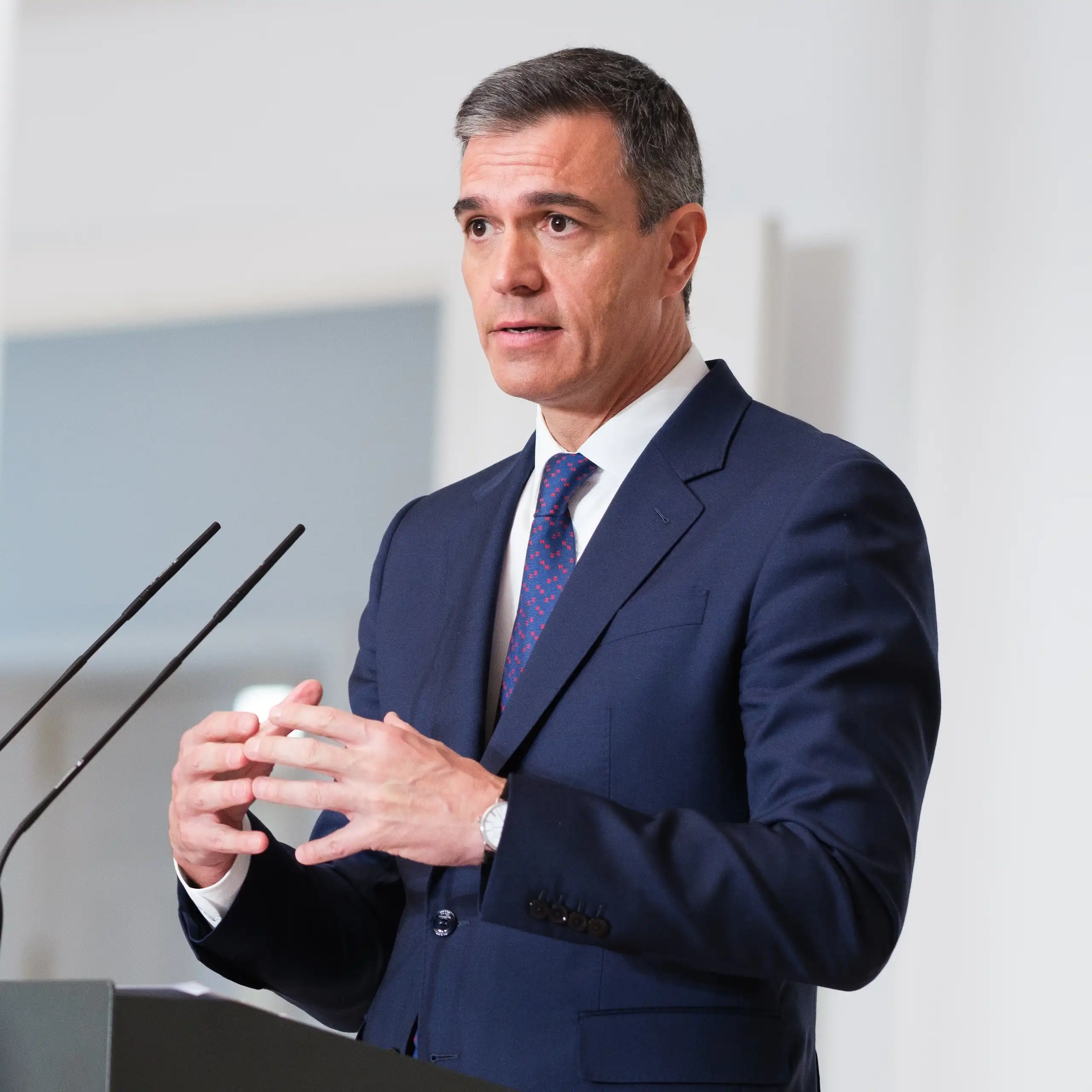 Pedro Sánchez speaks into a microphone