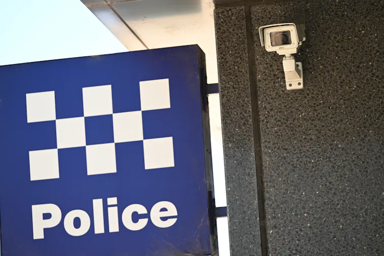A NSW Police sign and security camera in Sydney.