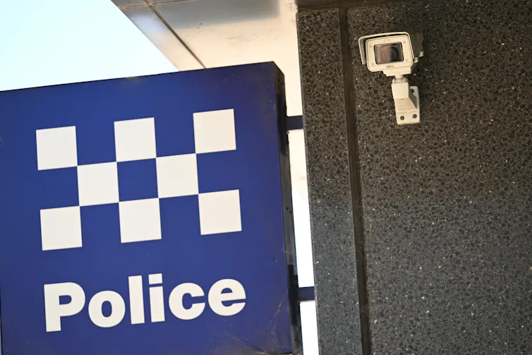 A NSW Police sign and security camera in Sydney.