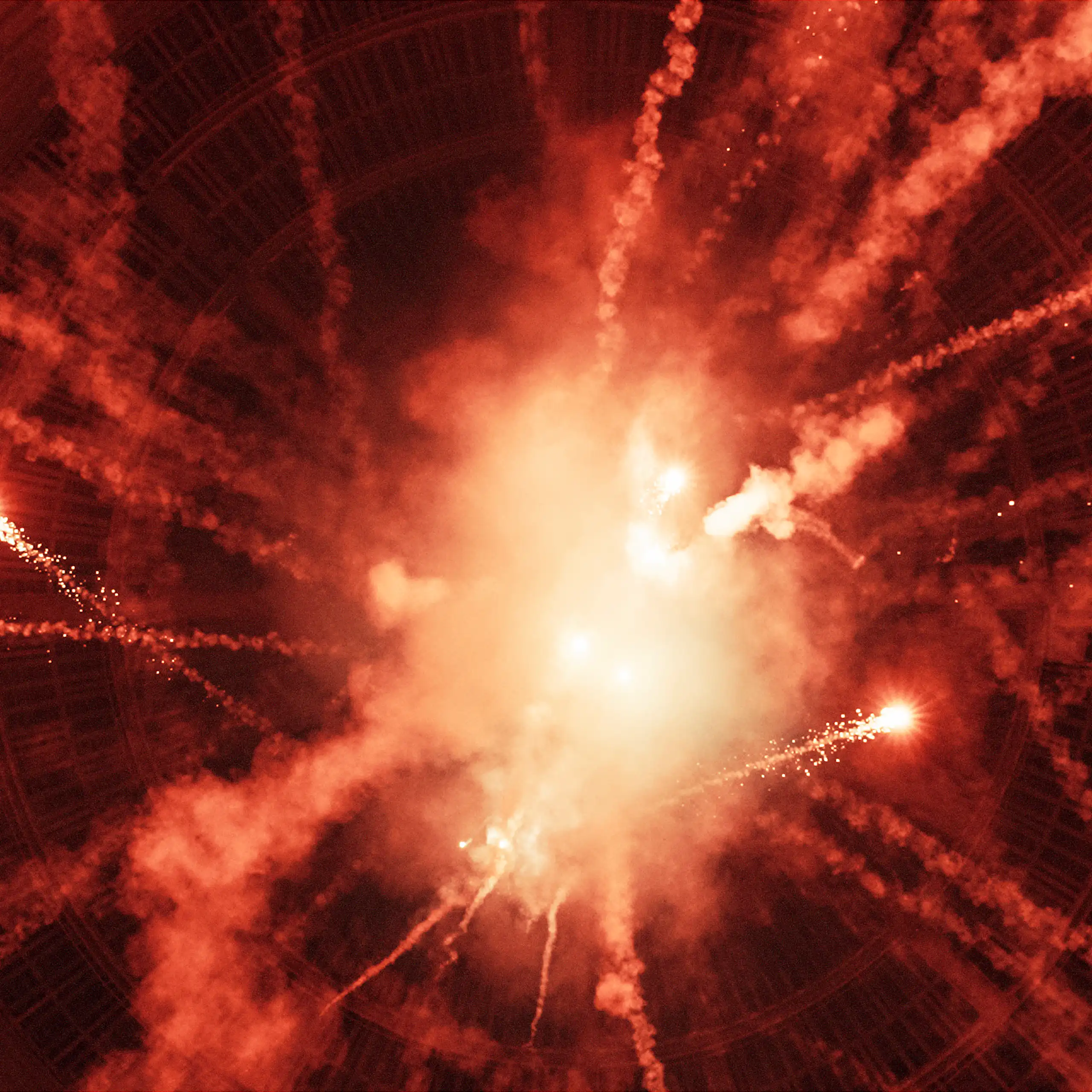 An artwork with a bright orange light and streaks of smoke and sparklers hurtling in various directions.