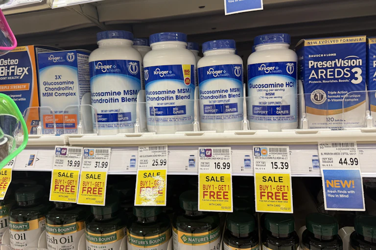 Different sized bottles of glucosamine/chondroiton on a supermarket shelf.