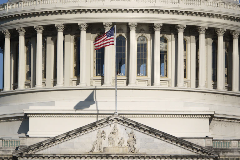 An American flags in front of a large federal building.
