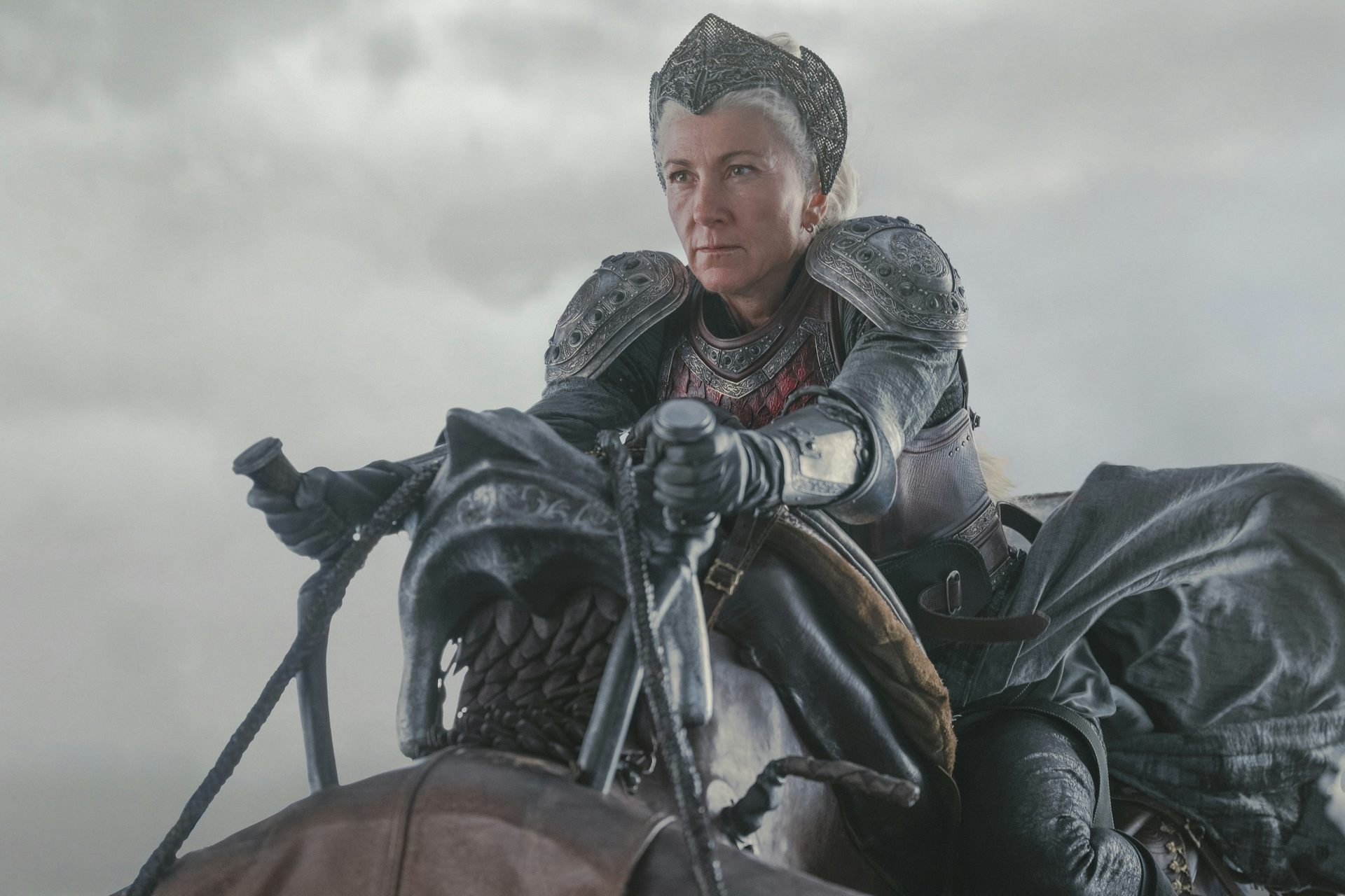 A woman in armour riding on a dragon