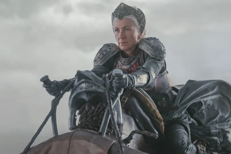 A woman in armour riding on a dragon
