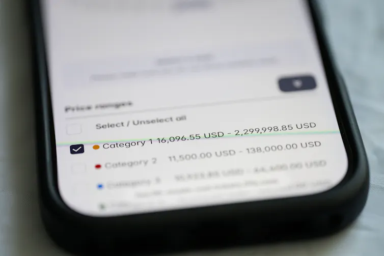 A phone screen shows some dollar figures.