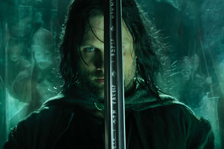 Promotional image for The Return of the King showing Aragon with his face partially obscured by a sword.