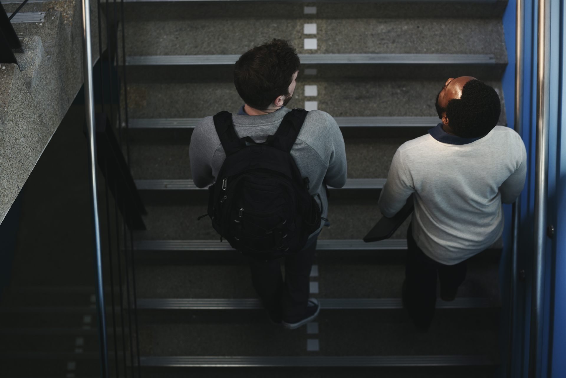Two teen boys walking up school stairs