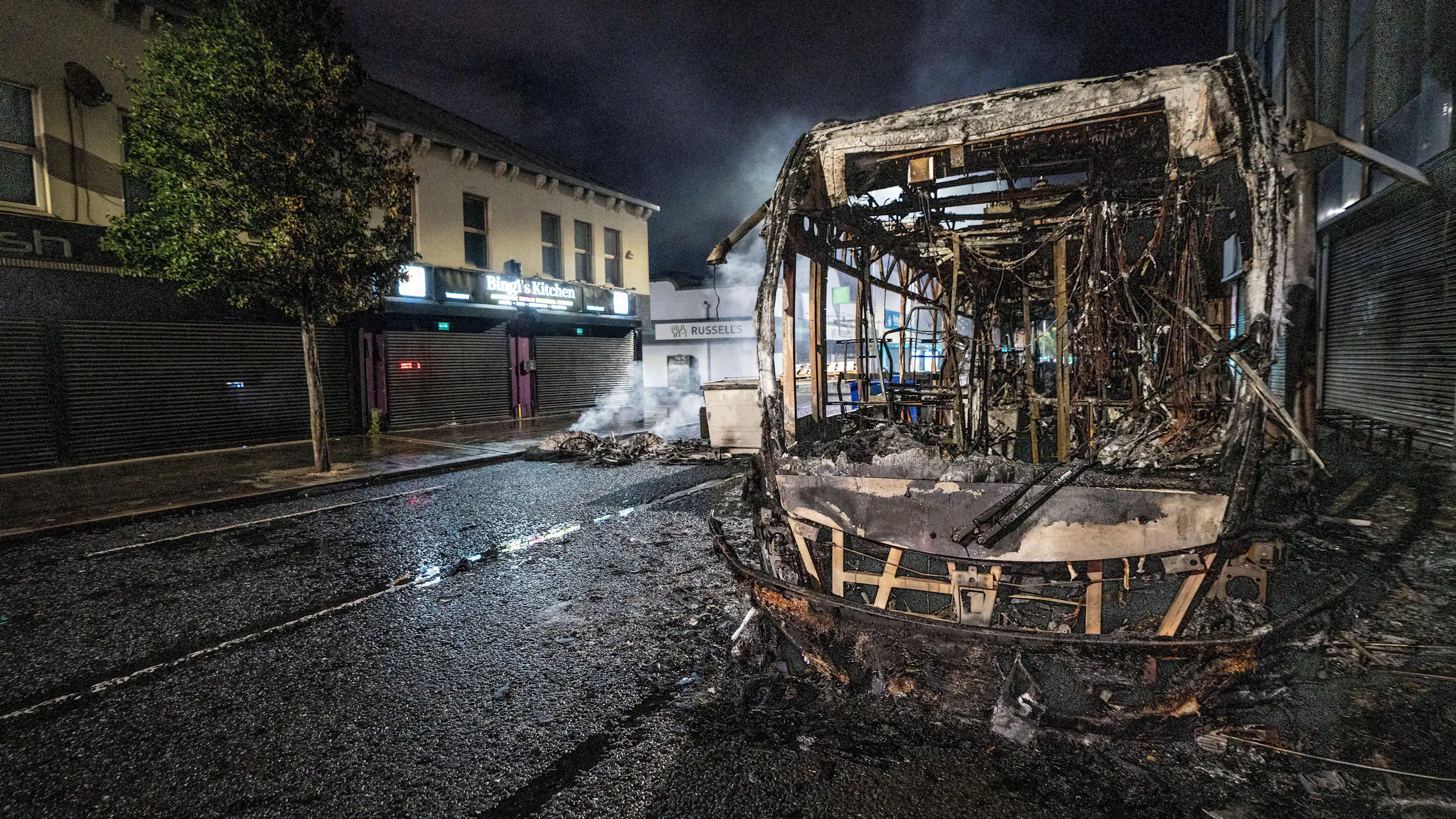 A burnt out bus seen after an anti-immigration protest in Belfast