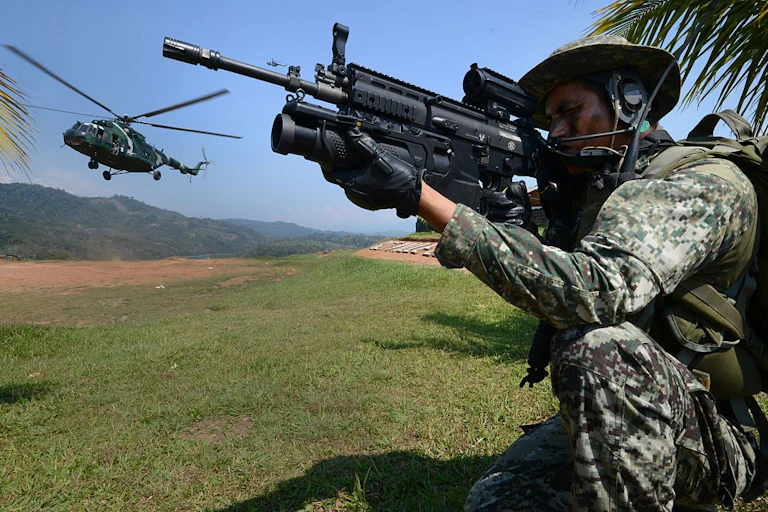 A soldier aims with his long gun.