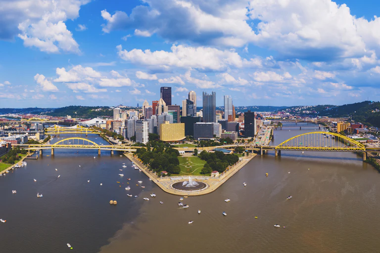 A wide shot of the point of a city and rivers merging.