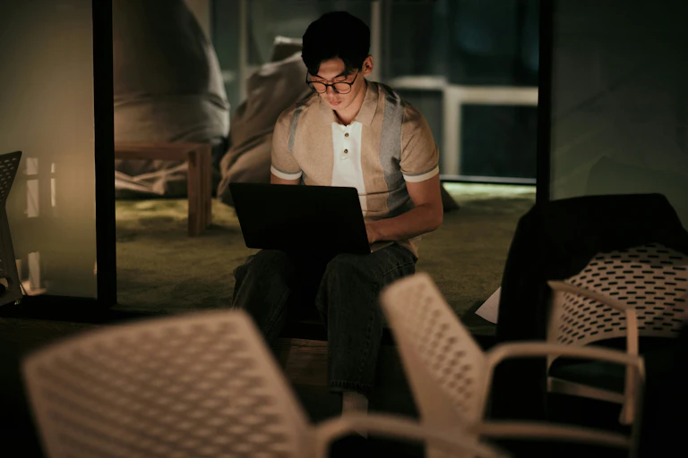A person working on a laptop late at night