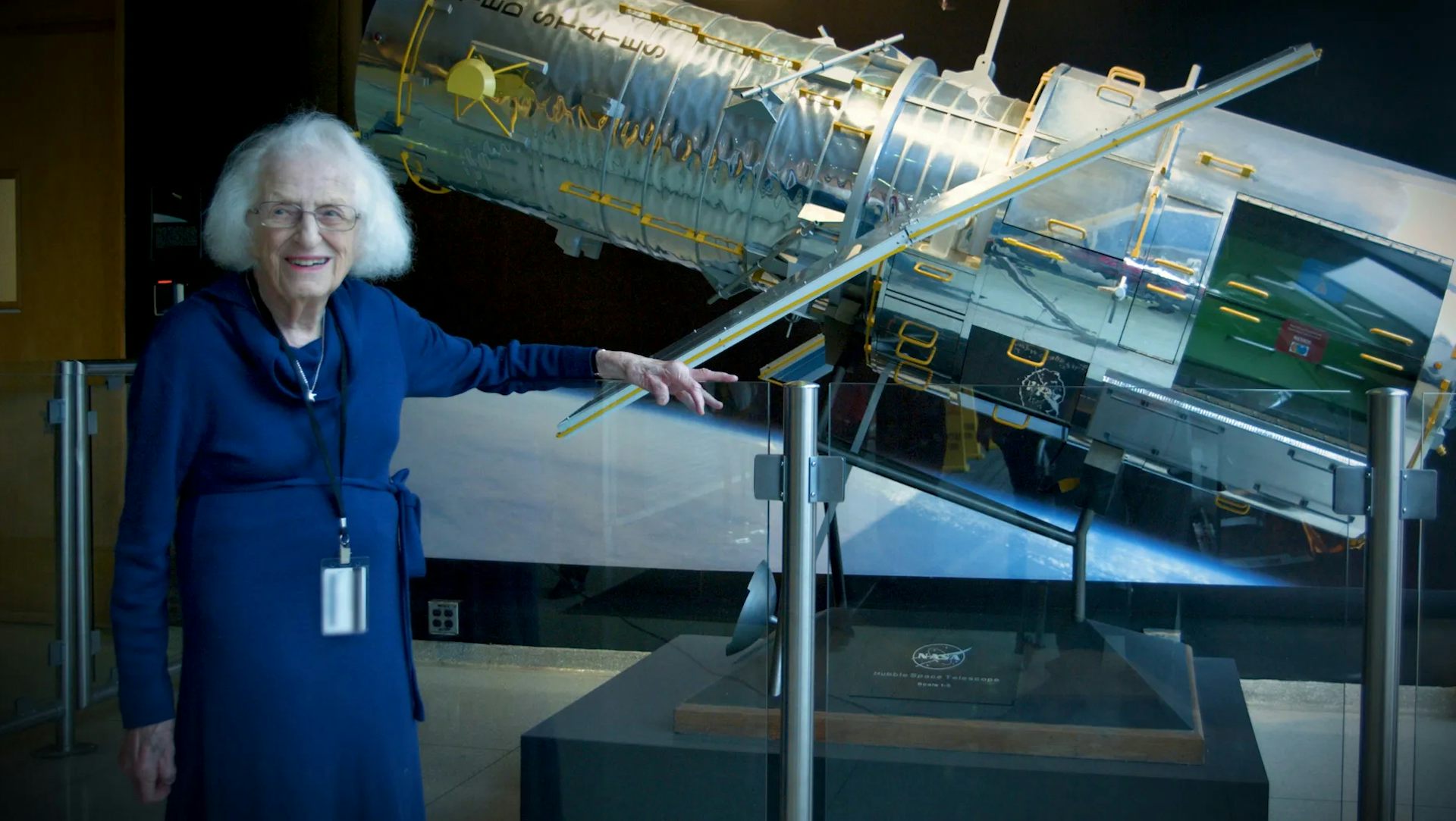 Nancy Grace Roman stands next to a scale model of the Hubble Space Telescope outside the Hubble control center at Goddard Space Flight Center in Greenbelt, Maryland.