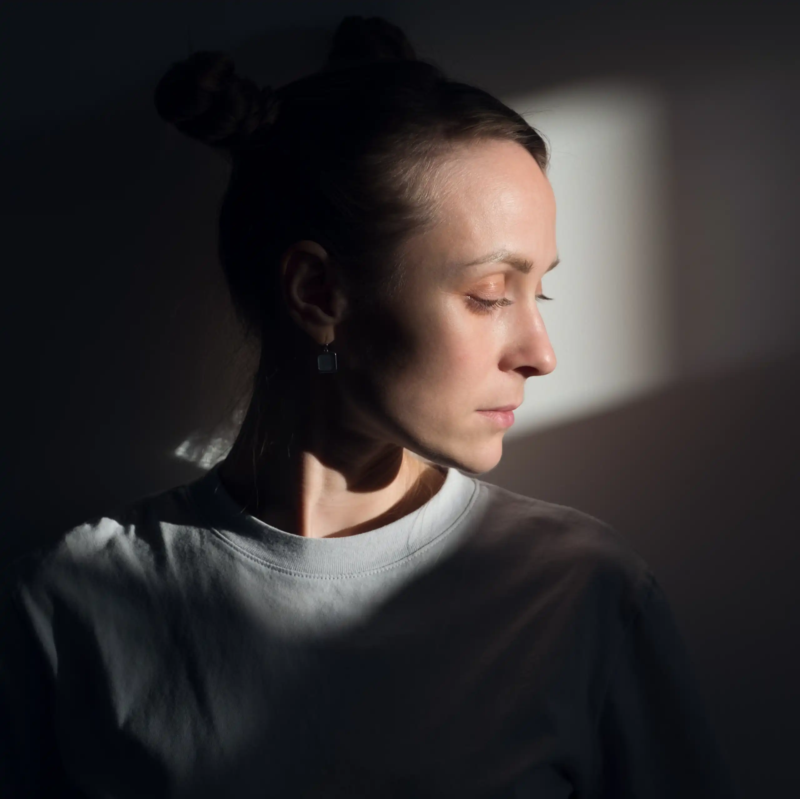 A woman in prison looks despondent