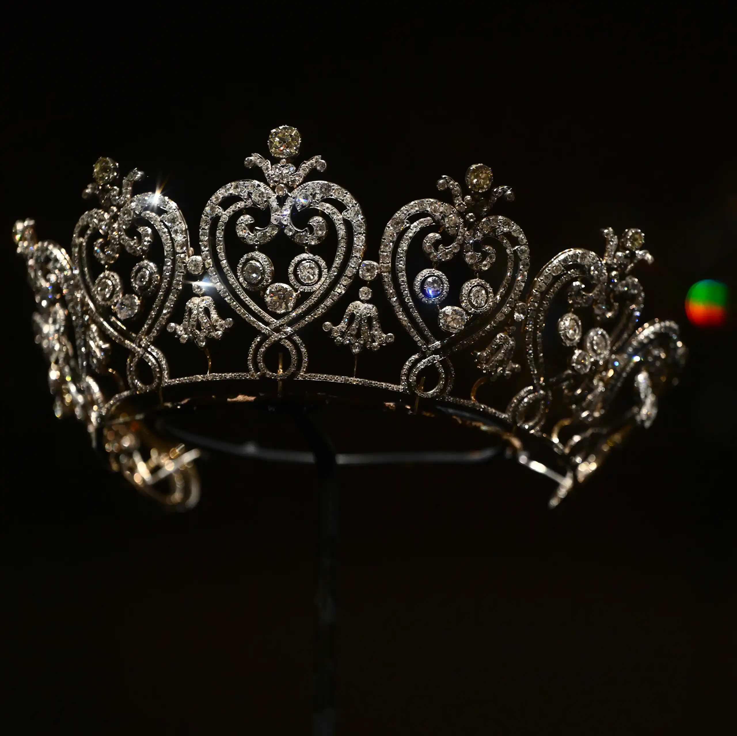 A sparkly tiara on display against a black background.