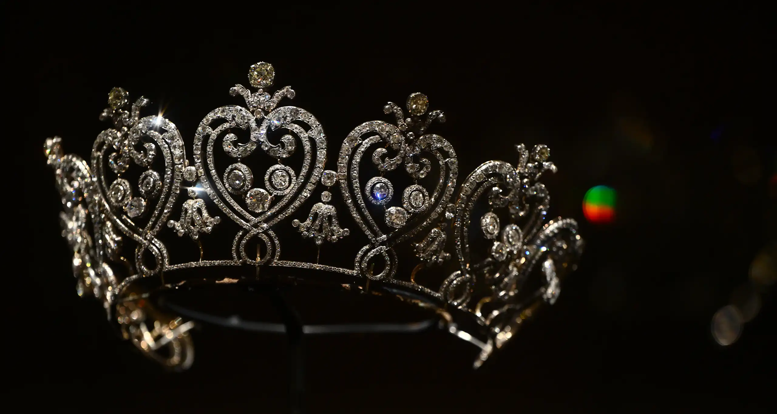 A sparkly tiara on display against a black background.