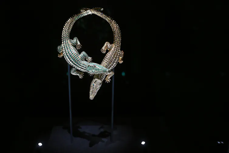 Display of a necklace designed to look like two crocodiles.