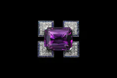 A brooch with a large purple gem in its centre.