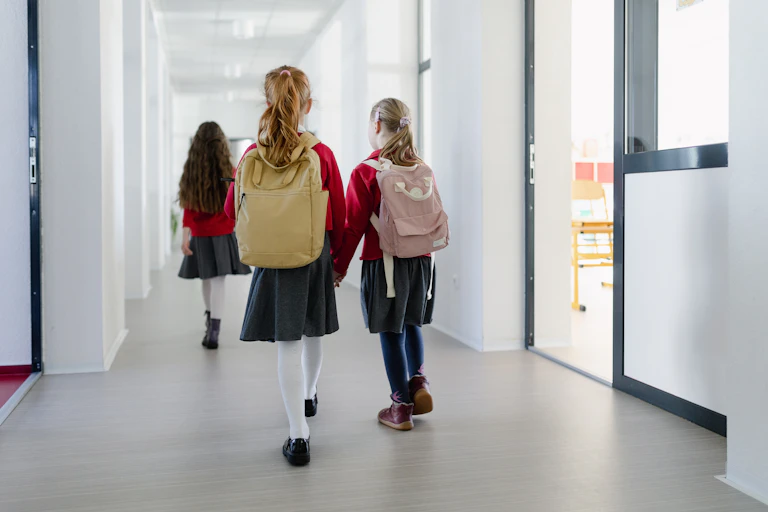 School children walking down corridor