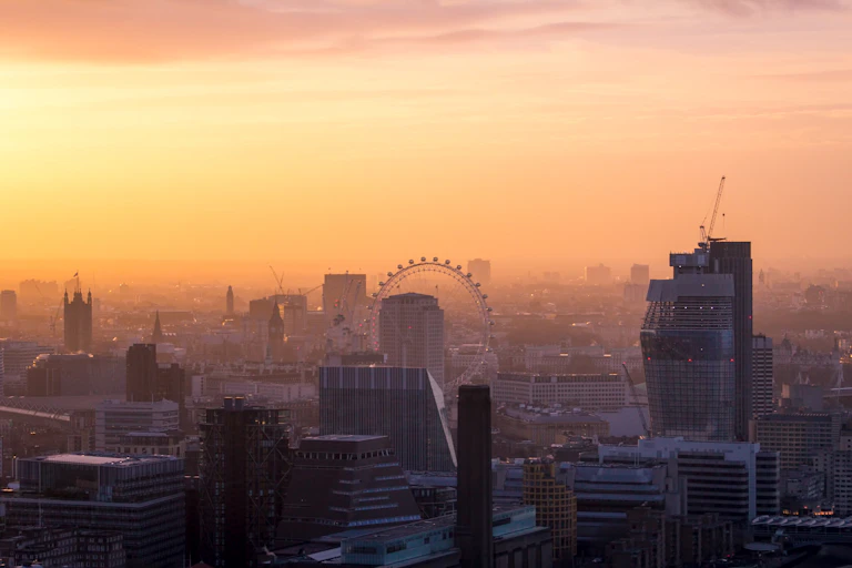 smoggy skyline of London city, orange sky