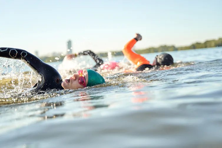 Athletes swimming in open water.