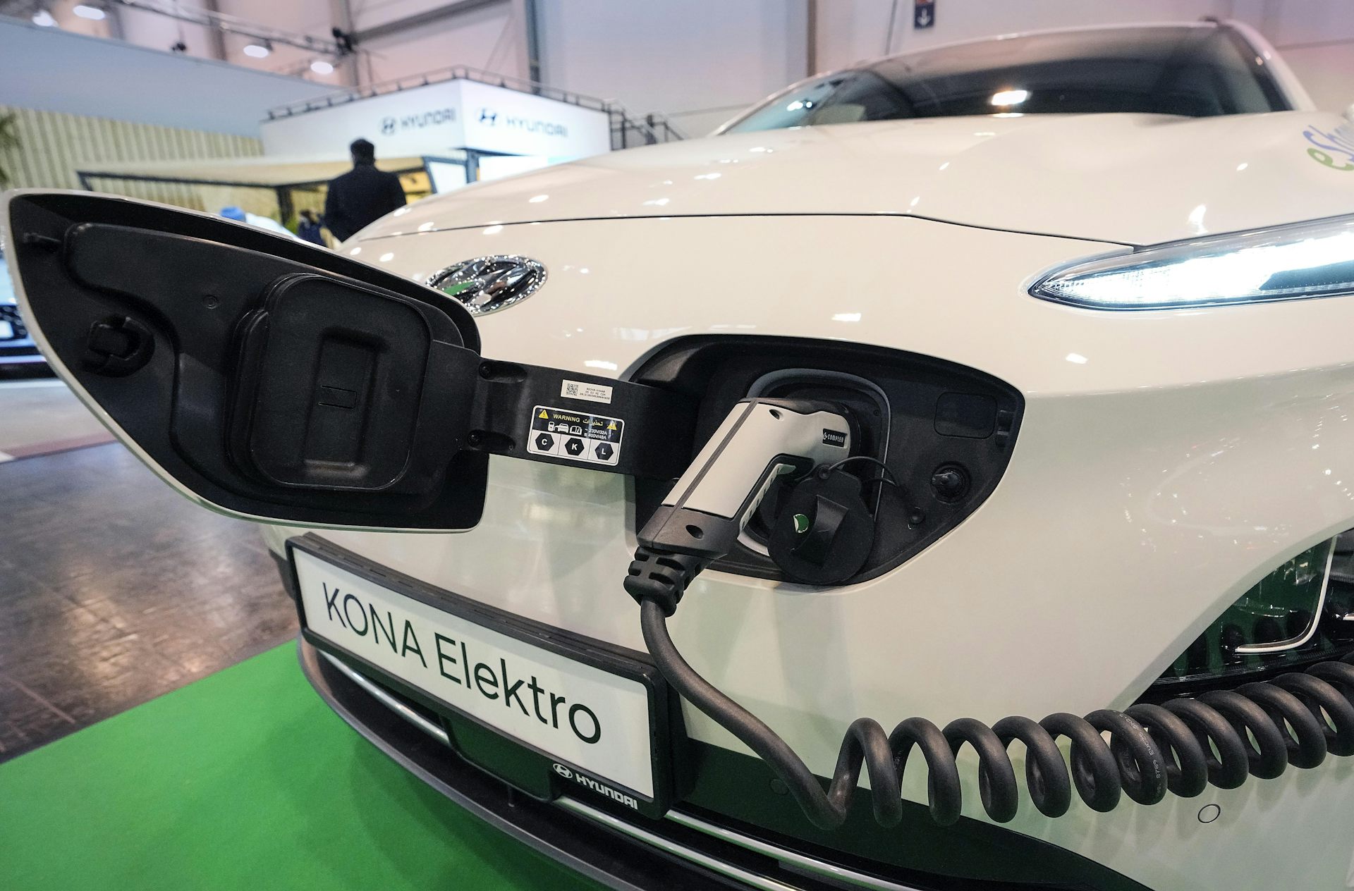 A while Hyundai Kona electric car is charged at a motor show in Essen, Germany, on Dec. 2, 2021.