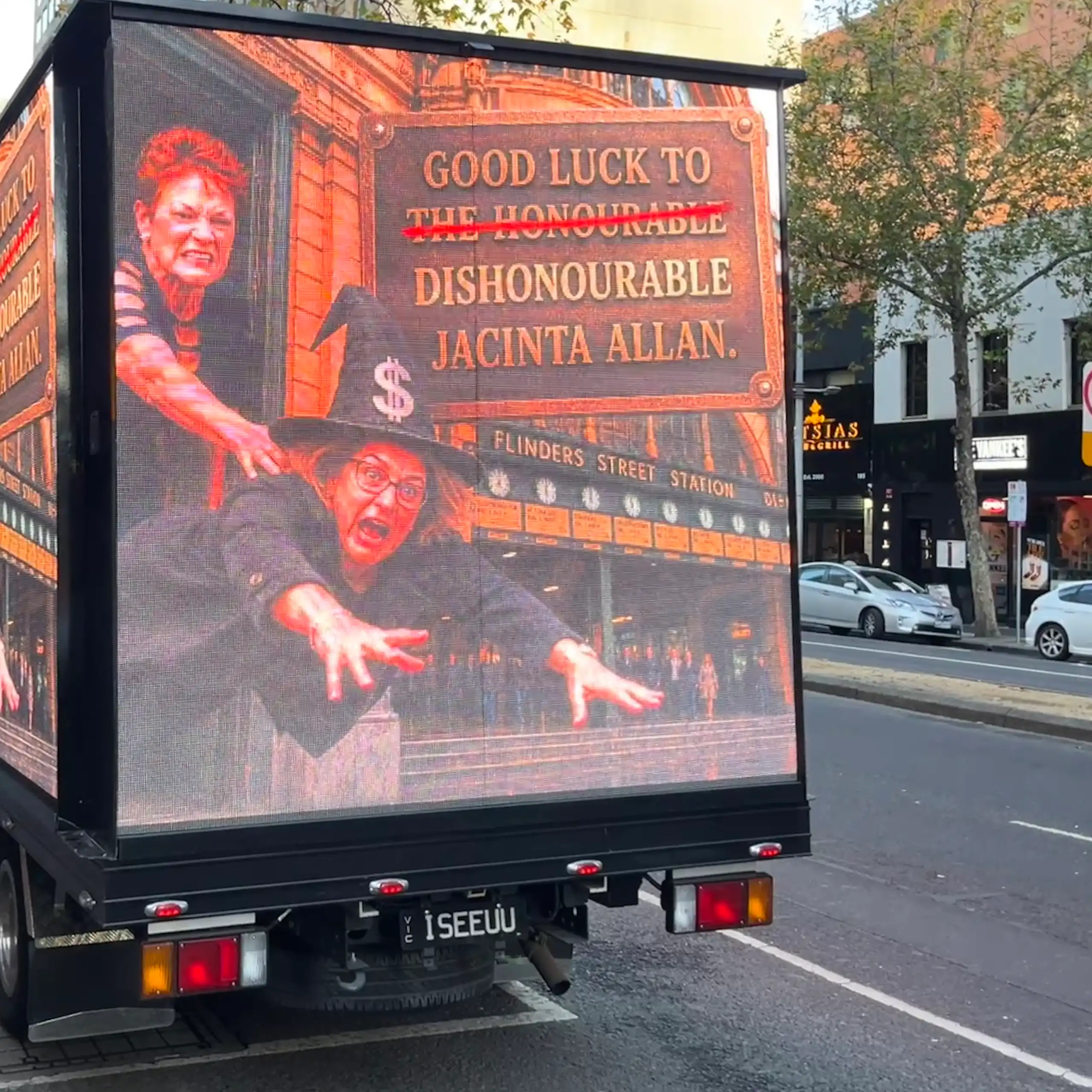A mobile advertisement truck displaying an AI-generated photo of One Nation leader Pauline Hanson throwing Victorian Premier Jacinta Allan wearing a witch costume.