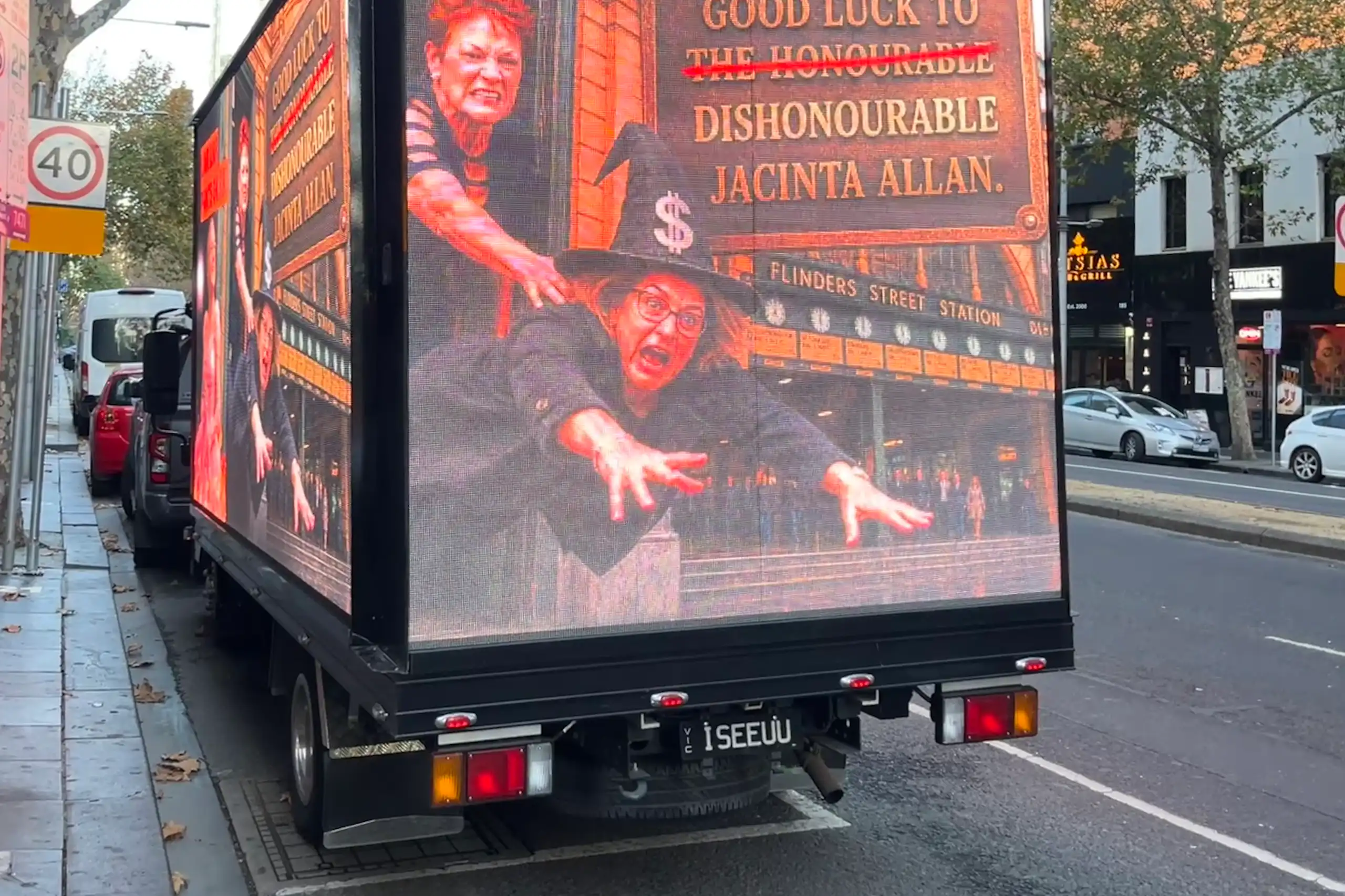 A mobile advertisement truck displaying an AI-generated photo of One Nation leader Pauline Hanson throwing Victorian Premier Jacinta Allan wearing a witch costume.