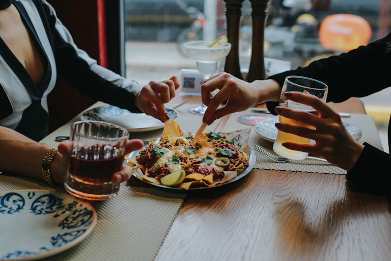 Friends dig into nachos over Friday drinks