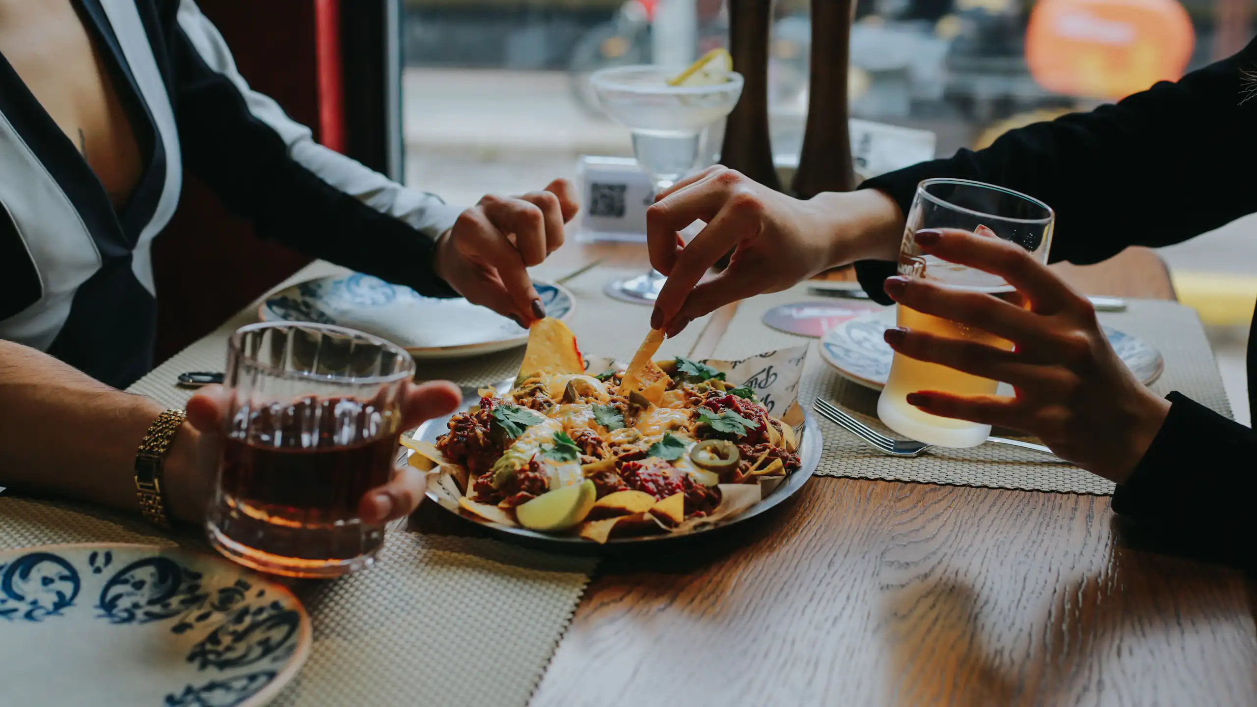 Friends dig into nachos over Friday drinks
