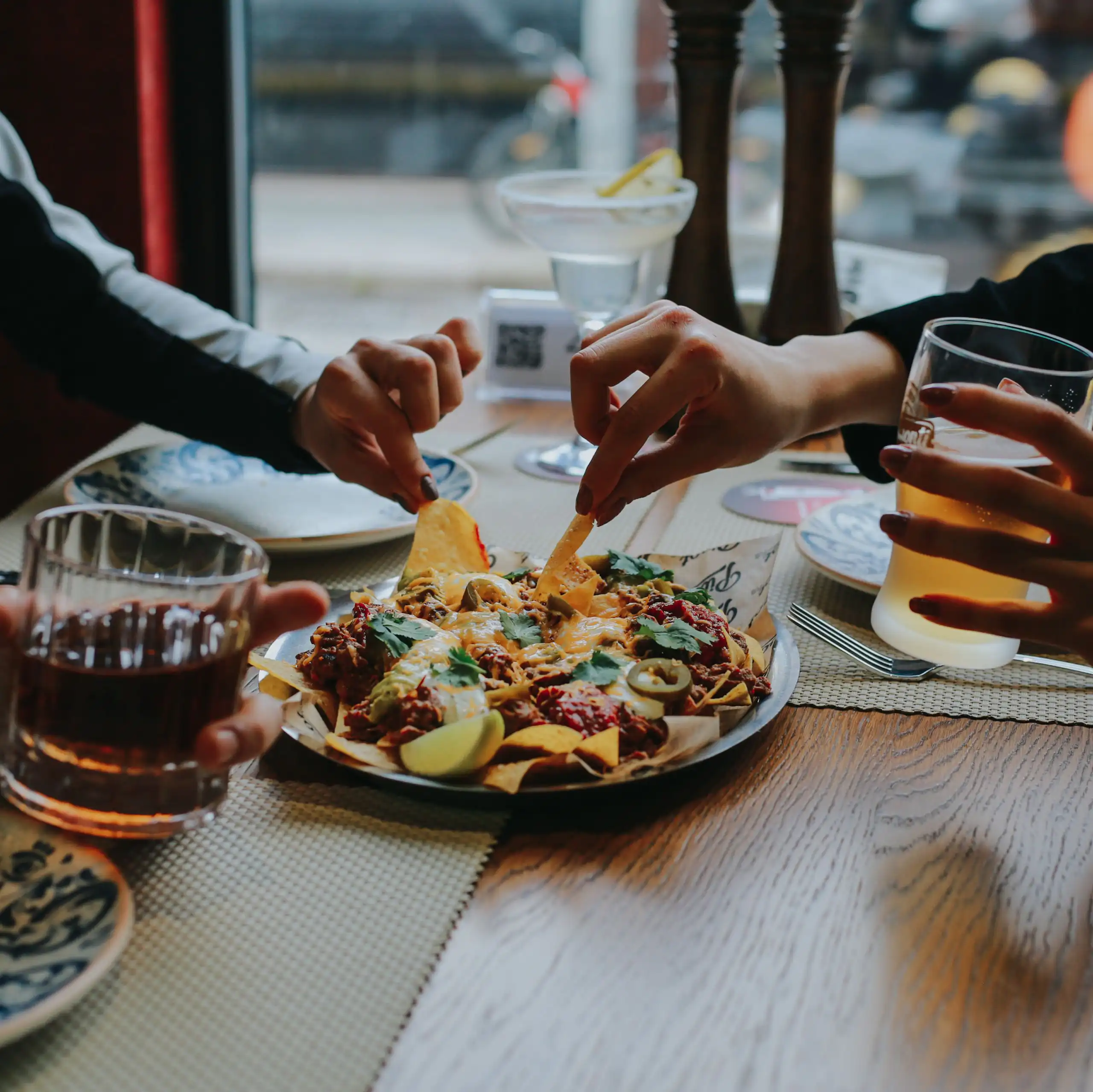 Friends dig into nachos over Friday drinks