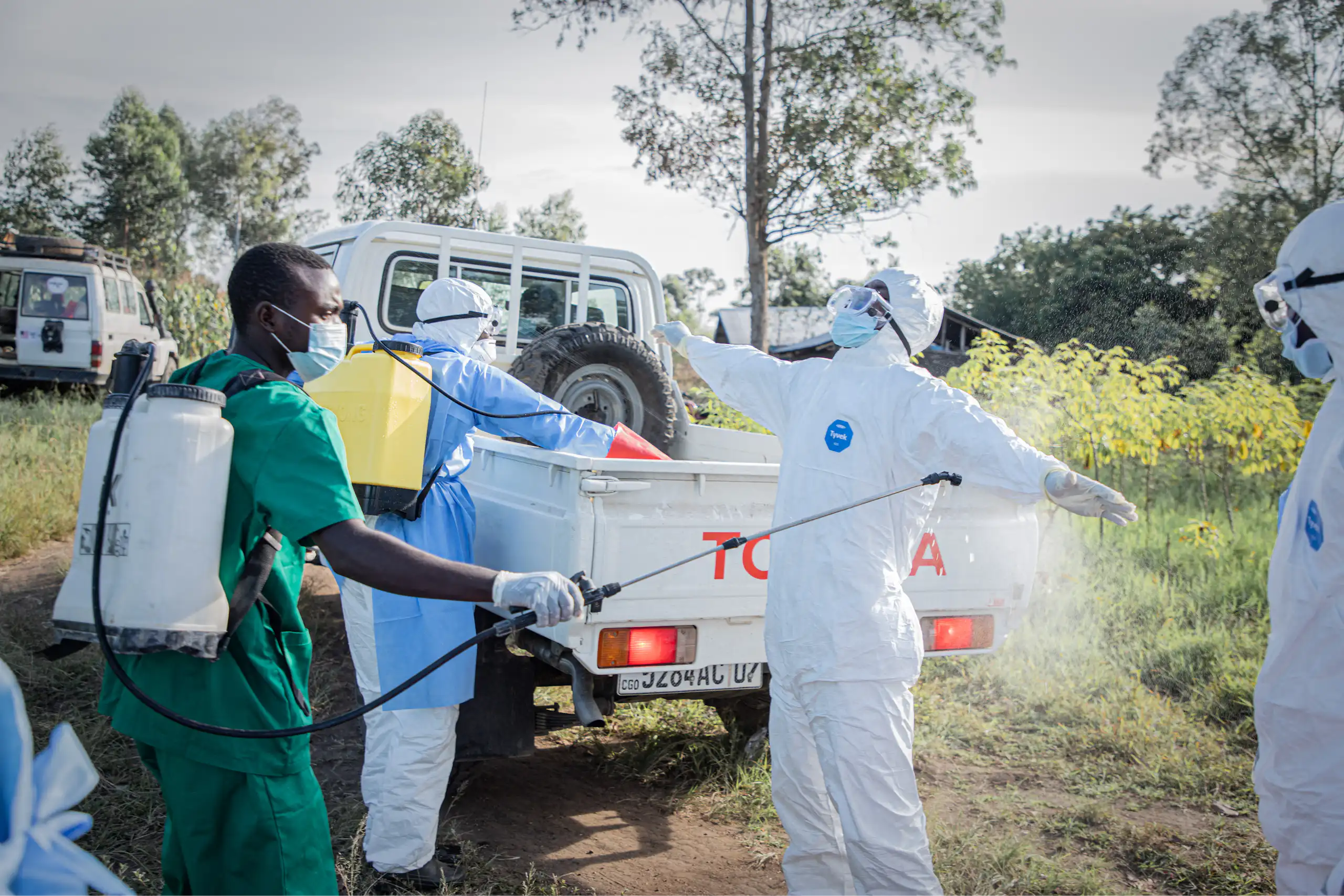 Des bénévoles se désinfectent après l'enterrement d'un enfant de 3 ans, présumément décédé des suites de la maladie à virus Ebola, à Bunia, en république démocratique du Congo, le 11 juin 2026.