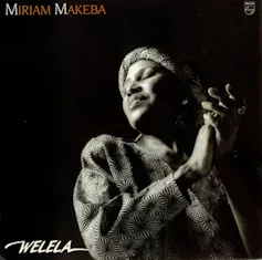 An album cover featuring a black and white photo of an African woman in traditional headgear holding her hands together, her face turned towards the light, eyes closed.