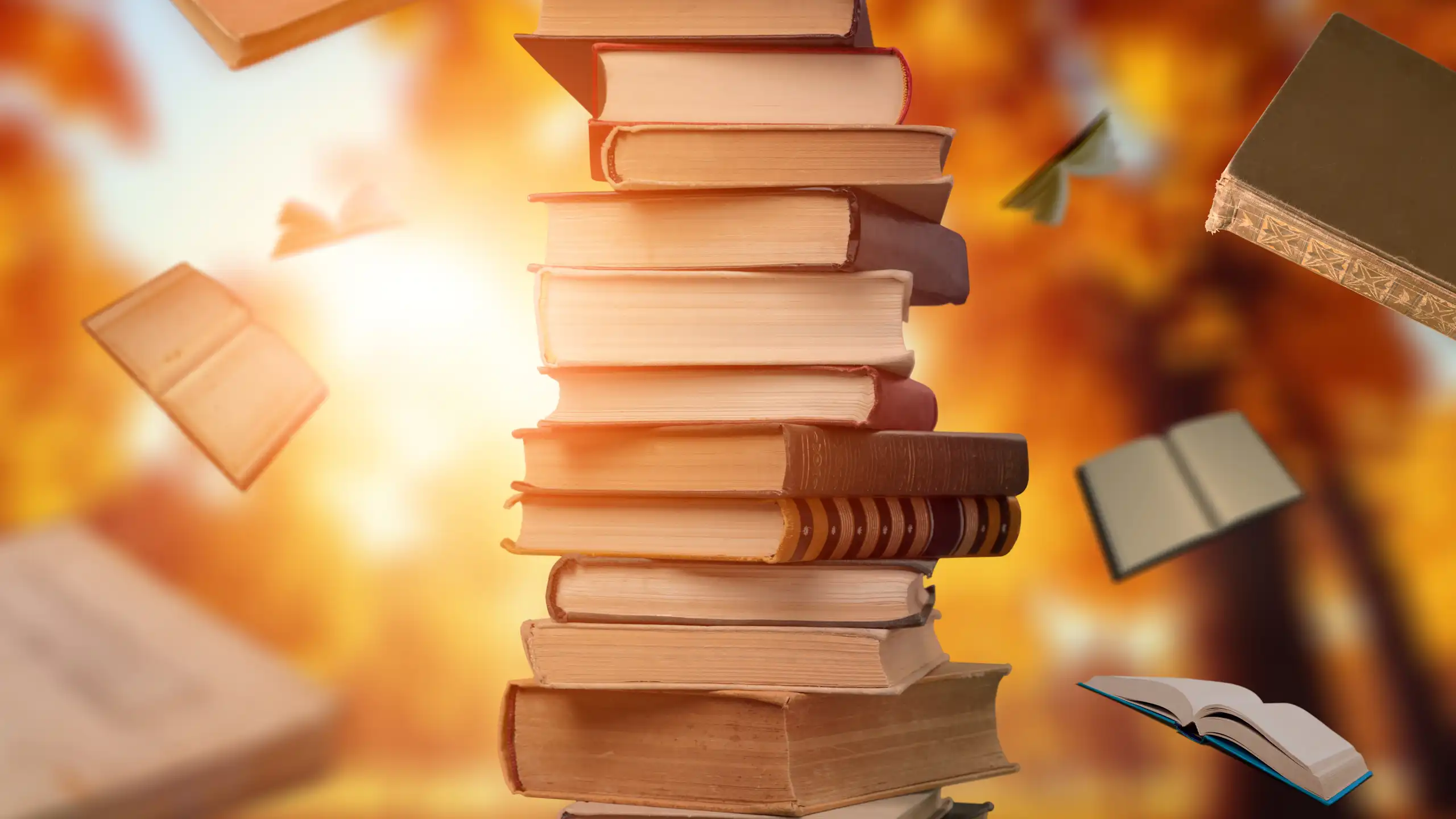 pile of books, some books flying in air