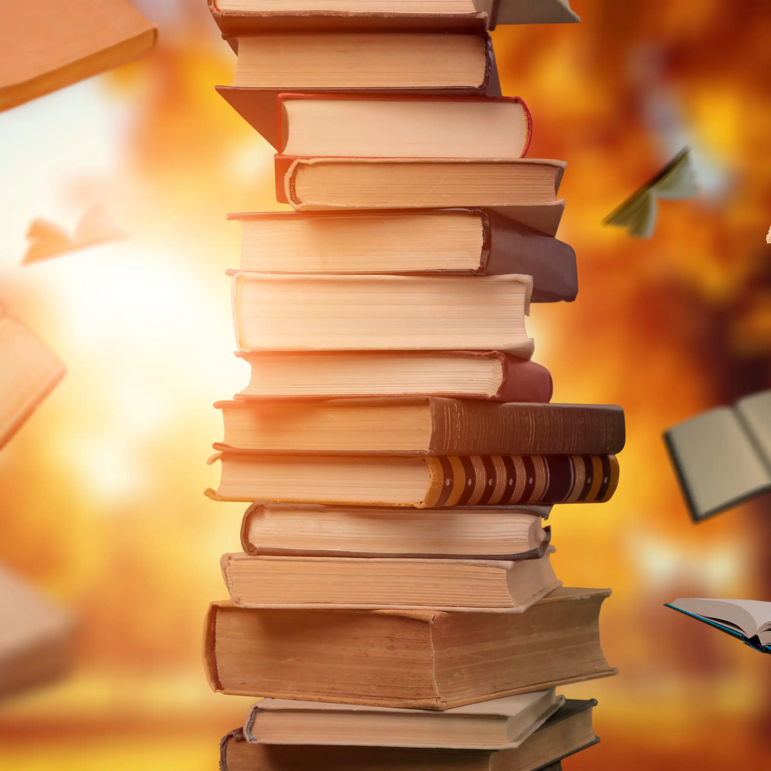pile of books, some books flying in air
