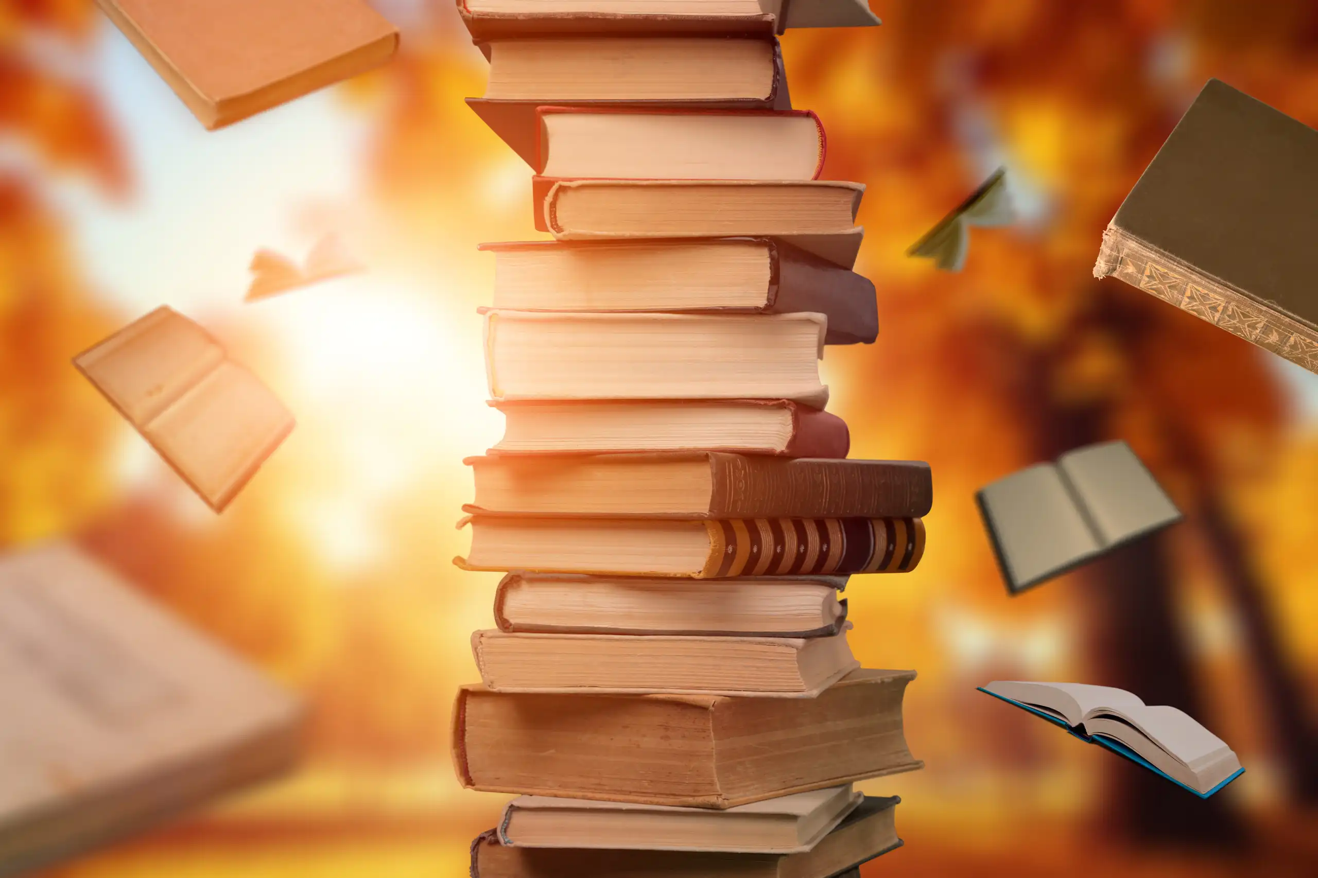 pile of books, some books flying in air