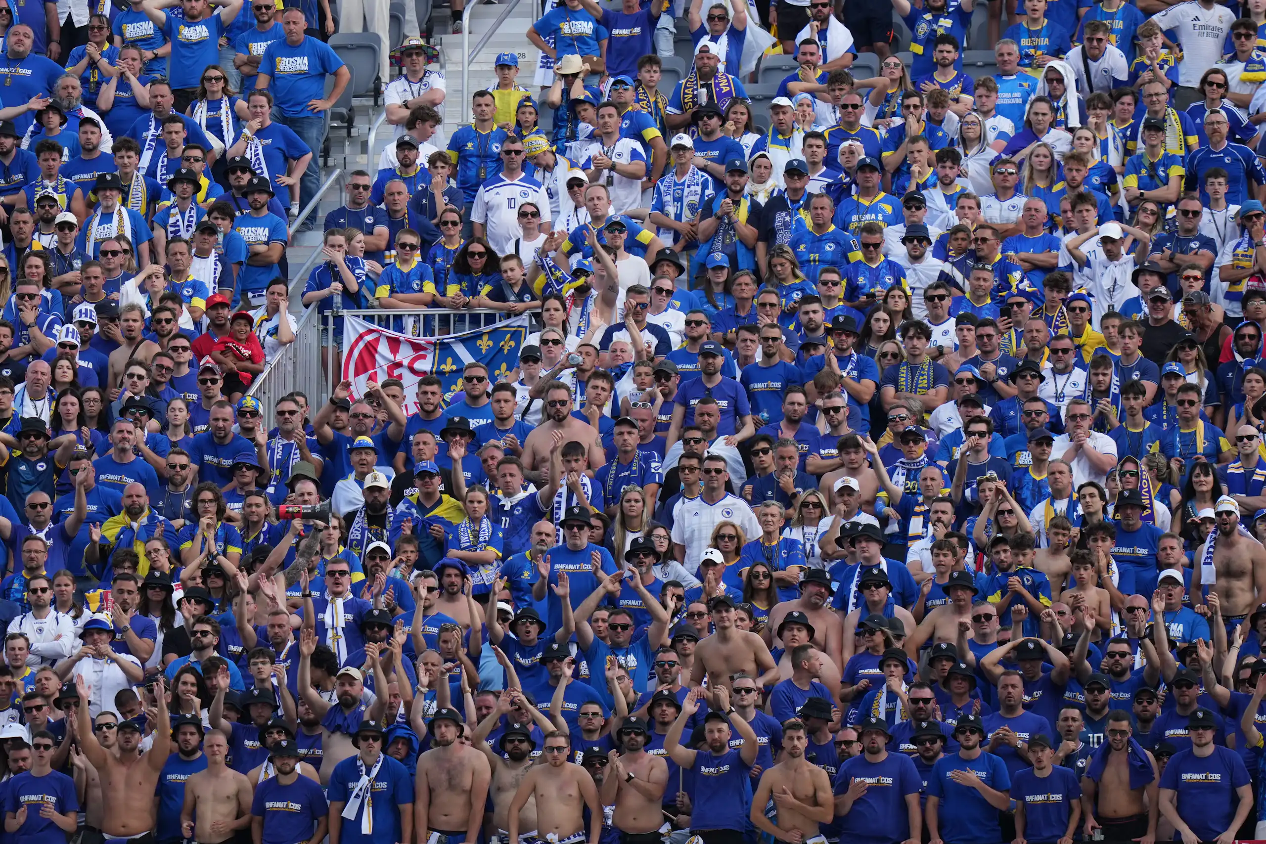 A crowd of people in stands at a soccer match.