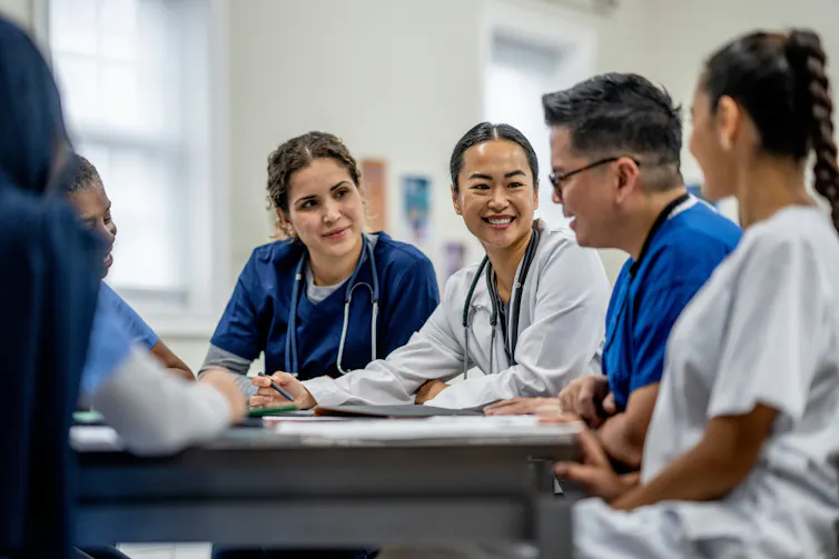 A group of medical students sits and talks.