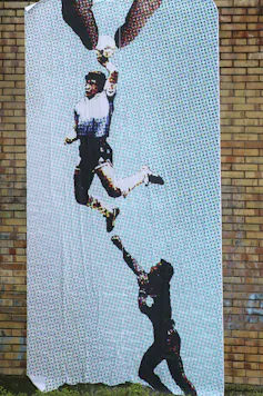 A large poster shows a man punching a ball being lifted.