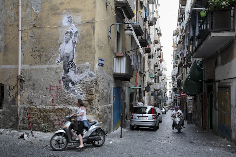 A mural on a wall shows a man punching a ball.