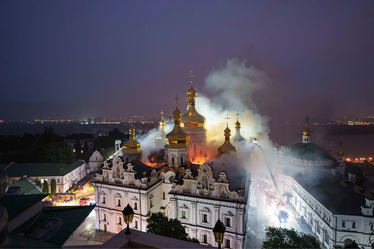 Rescue workers try to put out a fire at the Dormition Cathedral of thousand-year-old Monastery of Caves, also known as Kyiv Pechersk Lavra, following a Russian strike on Kyiv, Ukraine, Monday, June 15