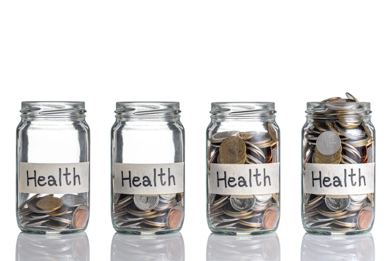 Bottles with different amounts of coins and labels that say health