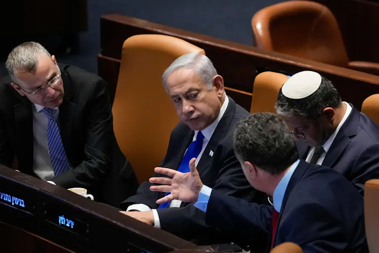 Israeli prime minister, Benjamin Netanyahu, speaks with ministers in the Knesset including national security minister, Itamar Ben Gvir, and minister of defence, Israeli Katz.